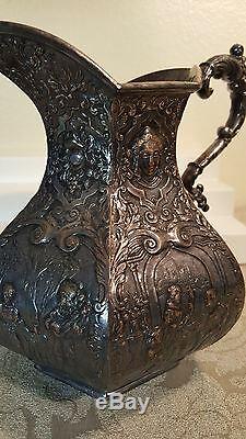 E. G Webster & Son repousse figural 8 water pitcher