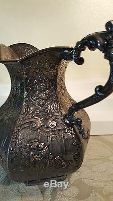 E. G Webster & Son repousse figural 8 water pitcher