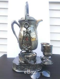 Silver Plated Tilting Water Pitcher 2 goblets figural nude winged fish. Wilcox